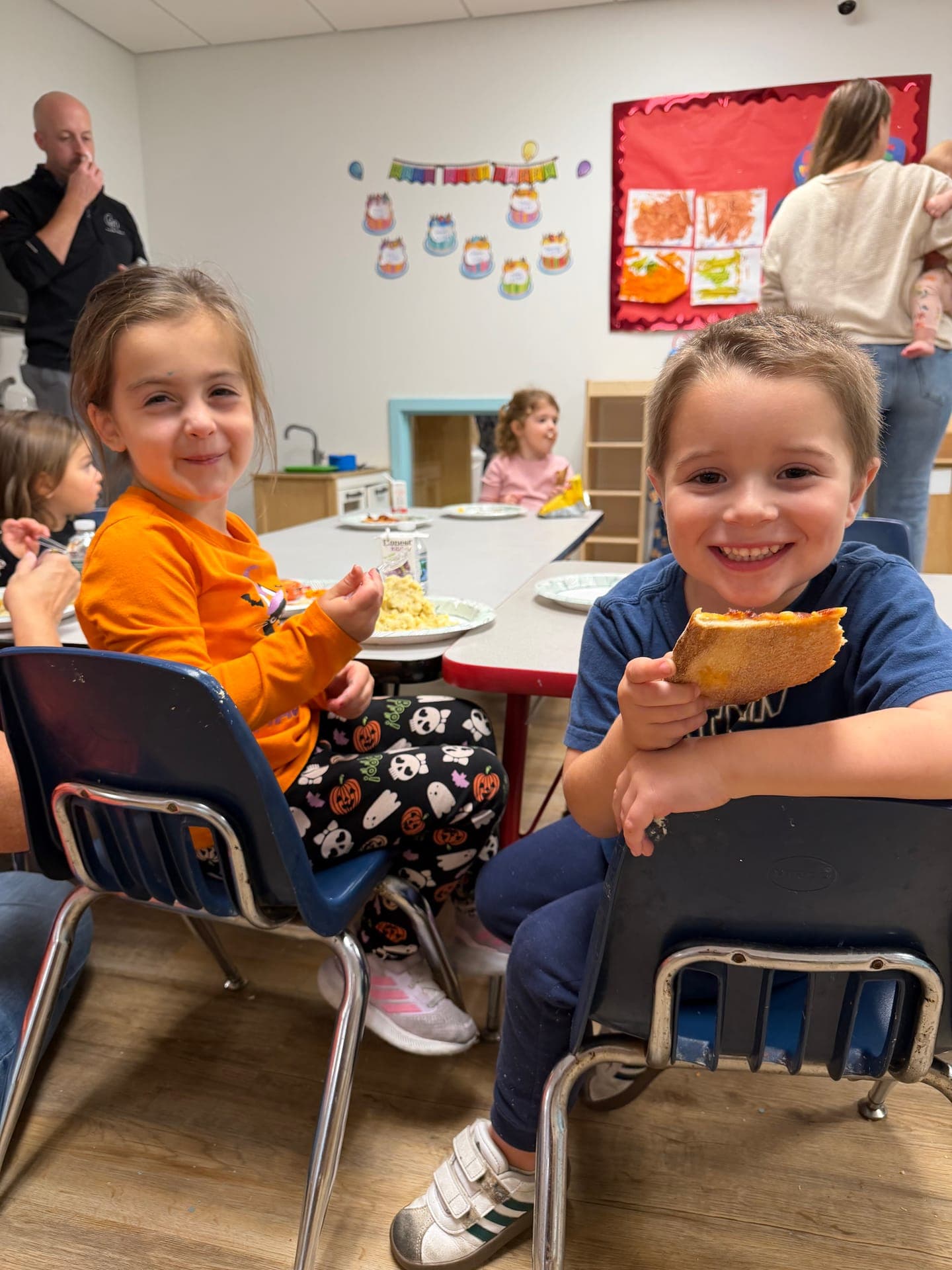 Two children smiling over dinner at the 2026 annual center dinner, Mountainside Children's Center