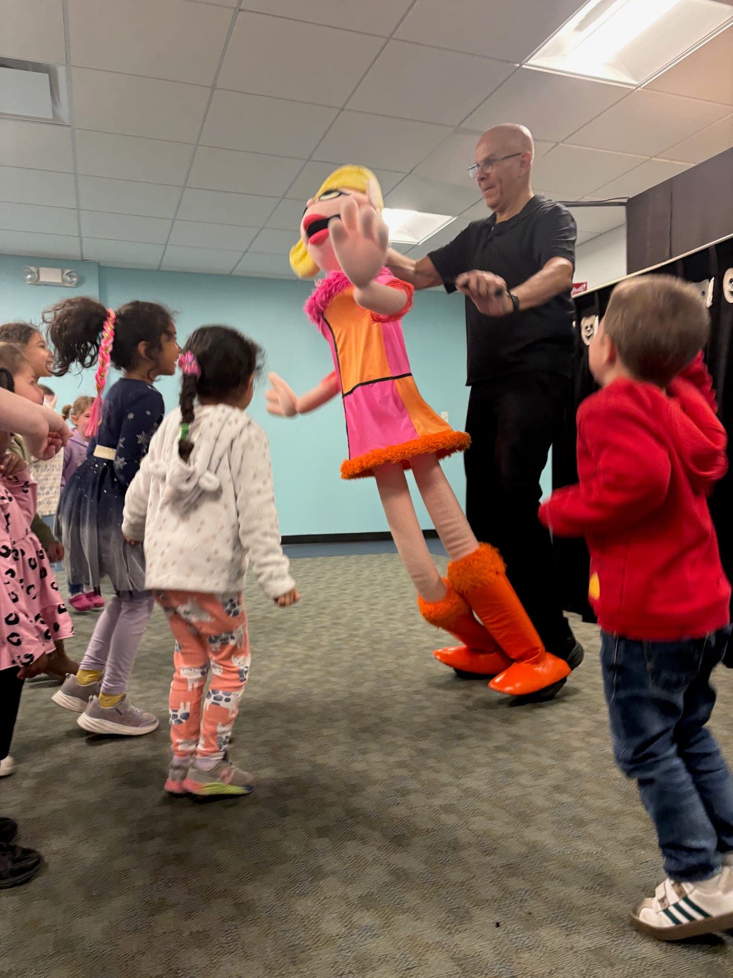 The Pumpernickel Puppet Man dancing a life-size puppet with children at Mountainside Children's Center