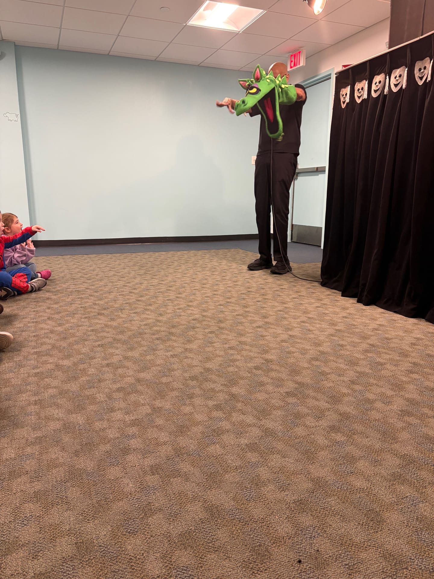 The puppeteer performing with the dragon puppet at Mountainside Children's Center
