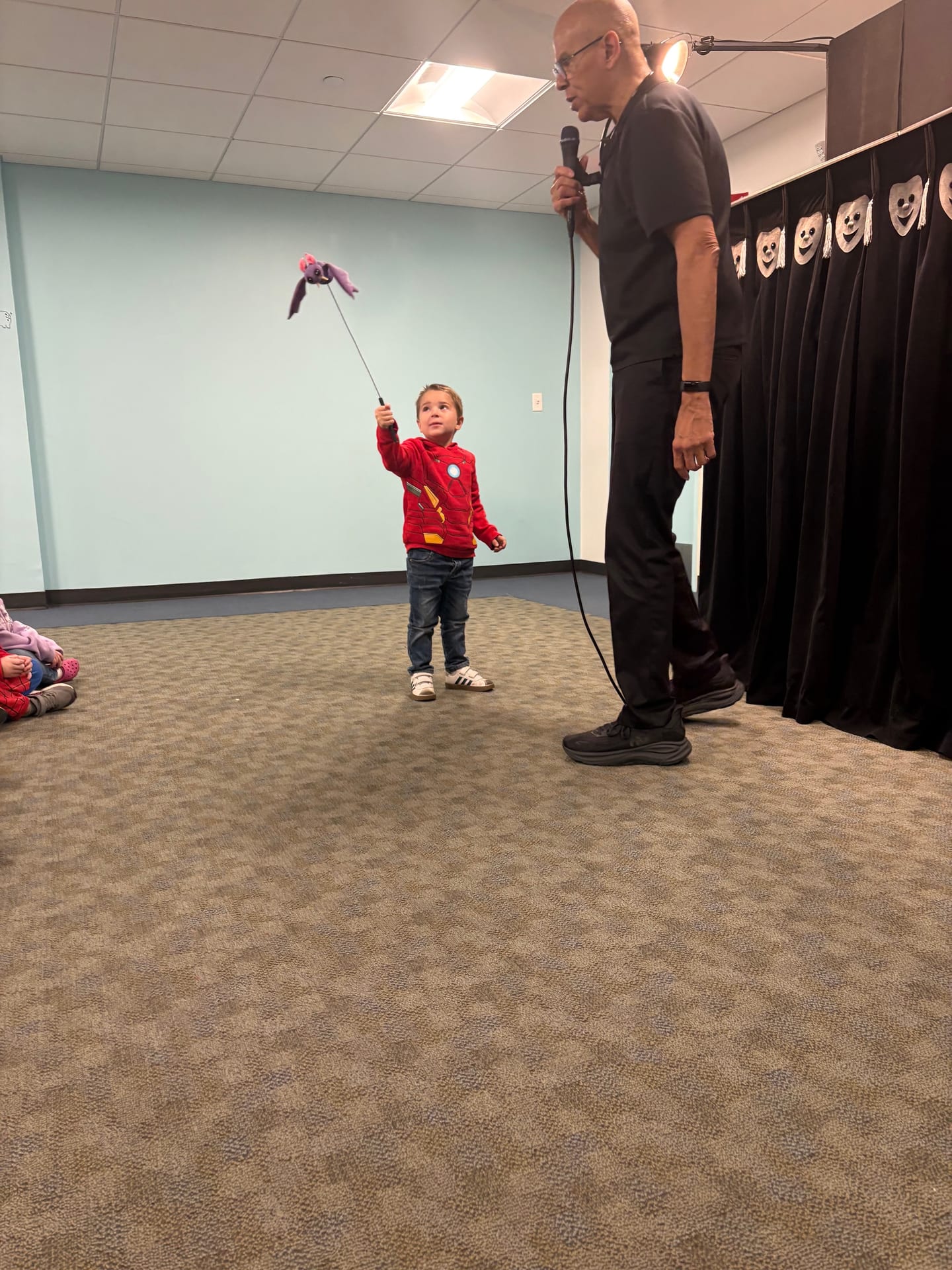A child trying a puppet on a stick during the Pumpernickel Puppet Man visit