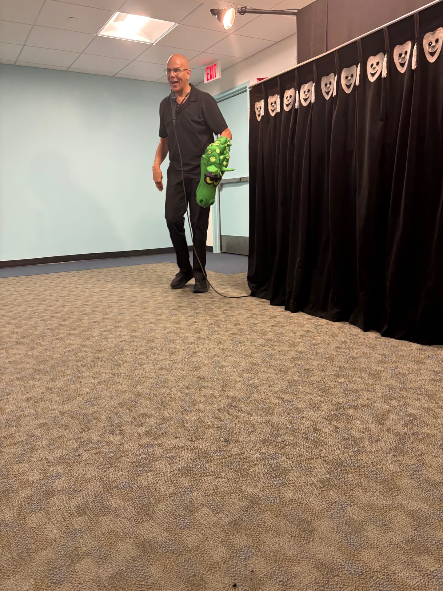 The Pumpernickel Puppet Man with the dragon puppet beside the stage